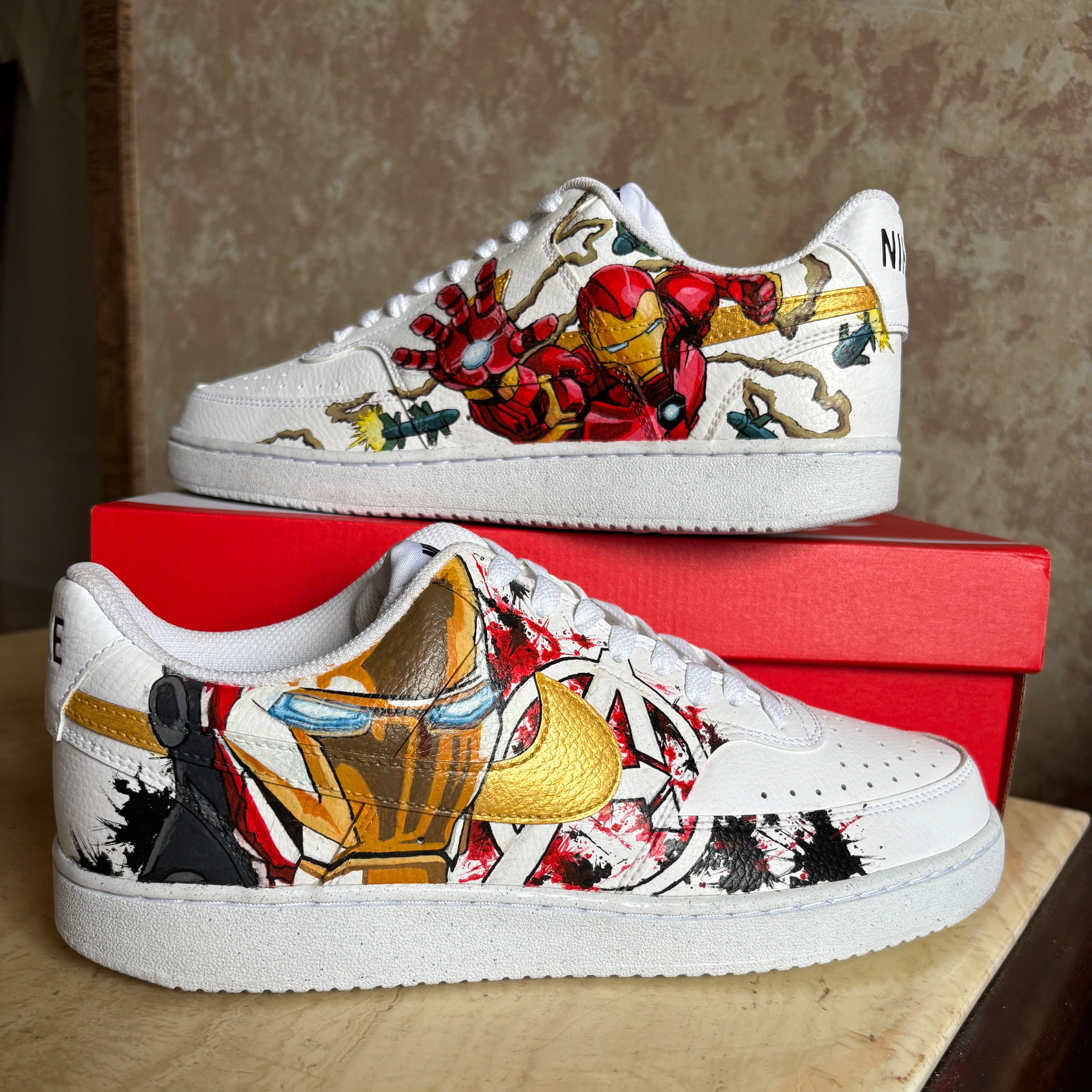 White sneakers with colorful designs on a red box